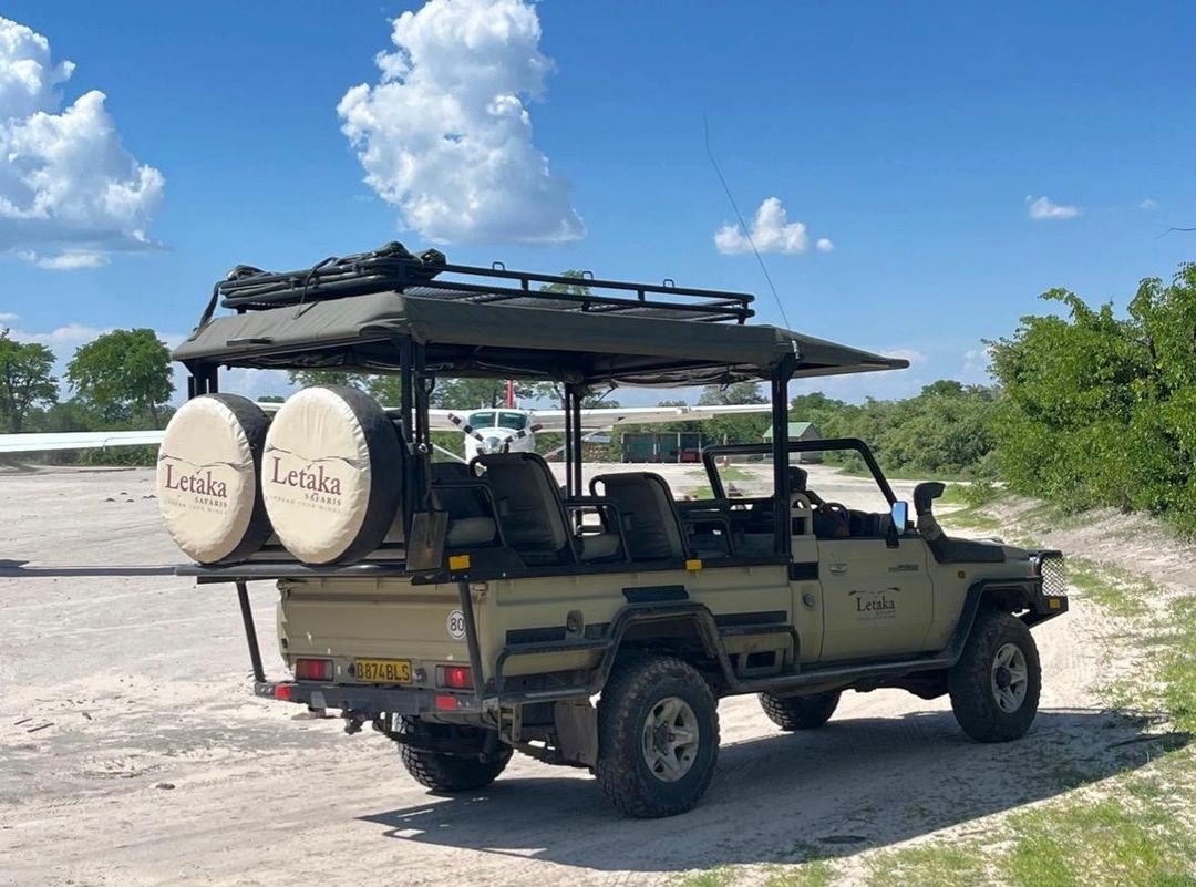 A Letaka Safaris-branded, open-sided 4x4 game drive vehicle.