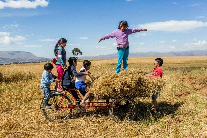 kids in a field Sacred Valley Sol y Luna Hotel Association Peru